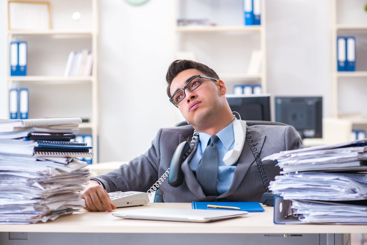 Desperate Sad Employee  Tired at His Desk in Call Center